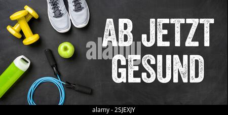 Fitness equipment on a dark background - healthy from now on Stock Photo