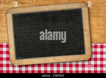 Table on a wooden background with a red checkered tablecloth Stock Photo