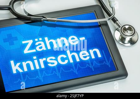 Tablet with the text Teeth grinding on the display Stock Photo