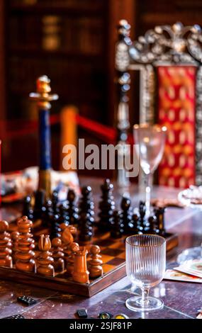Luxurious Vintage Chess Setup in an Elegant Royal Setting with Ornate Glassware and Regal Atmosphere Stock Photo