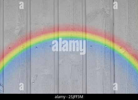 Wooden wall background with a rainbow Stock Photo
