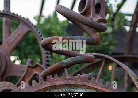 Industrial art made from old machinery parts, such as gears and springs. Rusty and bent. Stock Photo