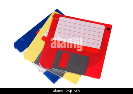 A stack of vintage computer colored floppy disks Isolated on white. Old technologies. Selective focus Stock Photo