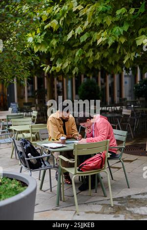 Young man with Down syndrome studyng with special educator teacher. Stock Photo