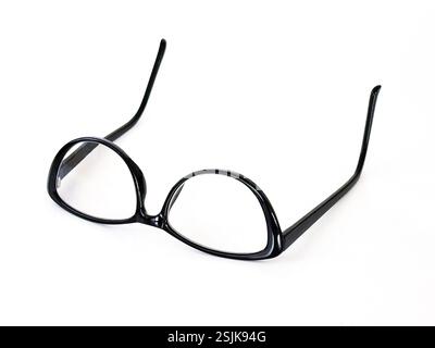 Pair of back glasses with a cateye shape frame isolated on a plain white background. Copy space. Stock Photo