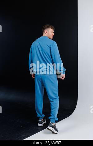 A stylish and fashionable male model dressed in blue activewear, showcasing the latest modern fitness fashion trends Stock Photo