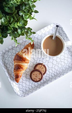 Delicious breakfast, meal, dessert. Croissant, cookies and cup of coffee on the table. Stock Photo