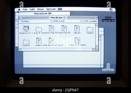 Vintage Macintosh computer screen displaying Mac Draw II software folder window on desktop finder and menubar  in classic black and white interface Stock Photo