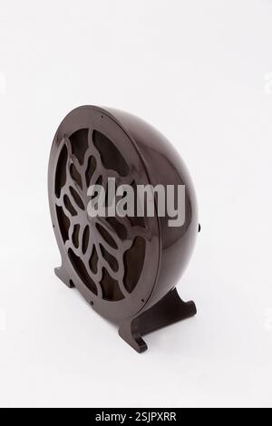 Vintage round bakelite antique style radio speaker with decorative grille on a white background Stock Photo