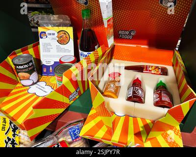 Kyiv, Ukraine - February 11, 2025: A selection of Asian food items, including sauces and coconut milk, in themed packaging. Stock Photo