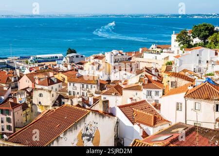 View of Lisbon old town Alfama district with houses clay orange roofs from viewpoint Portas do Sol, Lisbon, Portugal Stock Photo
