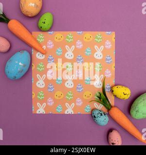 Easter pattern made with carrots and eggs on pastel purple background. Creative minimal holiday concept. Flat lay. Stock Photo