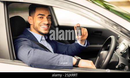 Handsome arabic businessman holding automatic car key Stock Photo