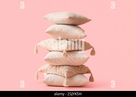 Stack of decorative pillows on pink background Stock Photo