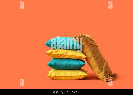 Decorative pillows on orange background Stock Photo