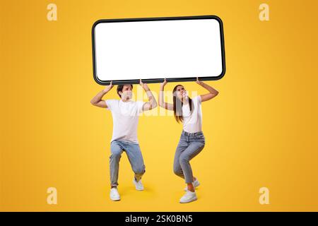 Couple holding heavy white empty smartphone screen Stock Photo