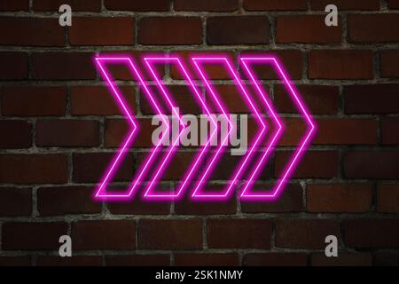 Pink neon arrow-shaped pointer on brick wall Stock Photo