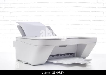 Modern multifunction printer on a clean white background ready for scanning, copying, and printing documents seamlessly Stock Photo