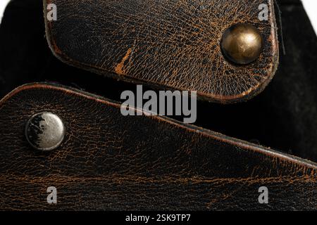 Closeup brown leather case with rivets on white background Stock Photo