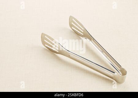 Stainless steel food tongs isolated on white background Stock Photo