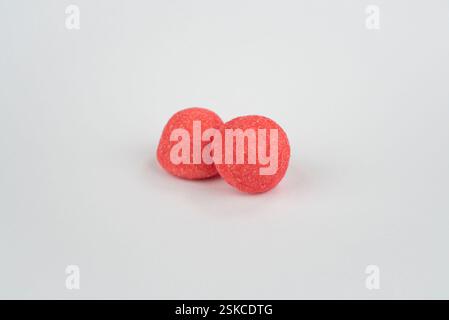 Red strawberry candies on a light grey background Stock Photo