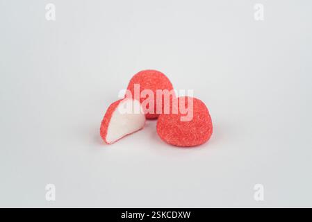 Red strawberry candies on a light grey background Stock Photo