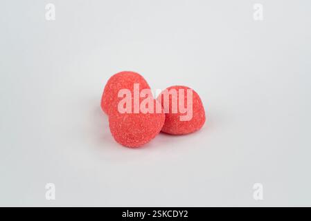 Red strawberry candies on a light grey background Stock Photo