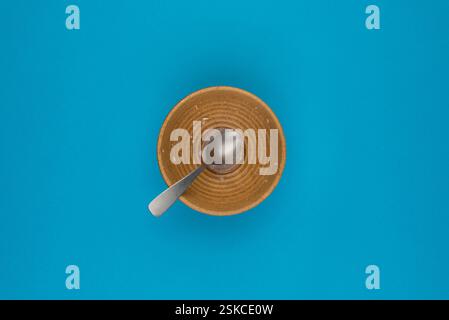 Top view of an empty cereal bowl on a blue background Stock Photo