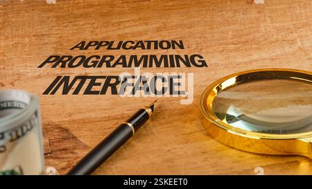 The concept of technology and development. Phrase, words, text APPLICATION PROGRAMMING INTERFACE text API written on paper, front view. Stock Photo