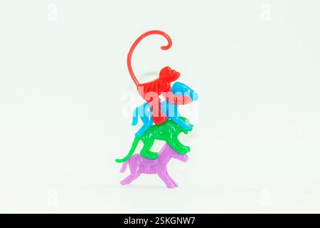 The toys are made of plastic, which children play with.Here are some purple and green toys.The toys include tigers, elephants, monkeys and giraffes Stock Photo