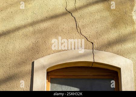 Crack in a wall on the window on the house construction defects Stock Photo