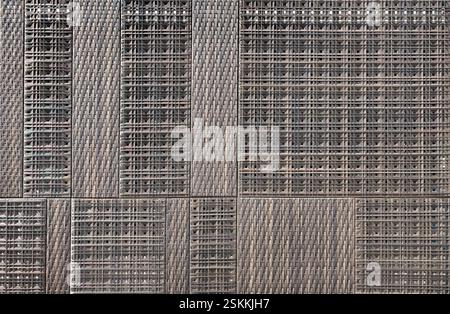 Dark brown natural rattan panel.  Series of wicker wall art in random weaving pattern. Seamless background texture. Stock Photo