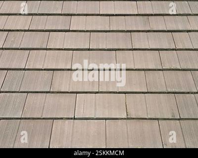 Roof shingles or slate tile material in warm brown color. Clay or slate tiles roofing is a common view for architectural roof finishes mainly in tropi Stock Photo