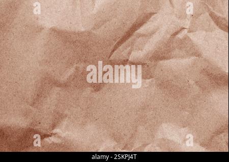 Elegant mocha mousse background on crumpled kraft paper texture. Mocha mousse grunge texture background. Aged kraft paper Stock Photo