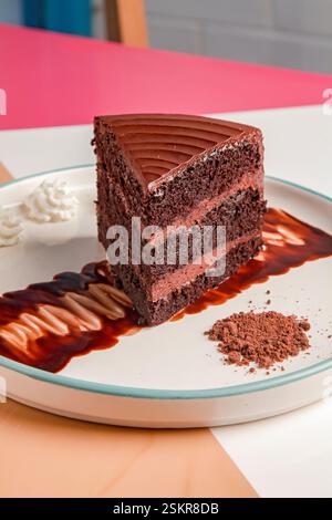 Three layered chocolate cake with cream and gelato scoop. Stock Photo