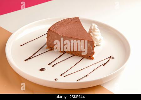 Chocolate cheese cake served with cream. Stock Photo