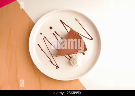 Chocolate cheese cake served with cream. Stock Photo
