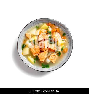Salmon fish soup isolated on white background. Traditional soup with red salmon and vegetables in bowl, top view. Stock Photo