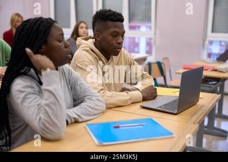 Students using laptop during class at university or high school Stock Photo
