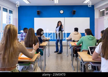 Teacher explaining lesson to diverse high school students institute Stock Photo