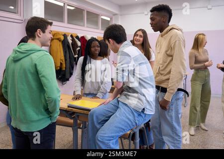 High school students chatting together in classroom Stock Photo