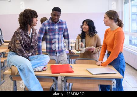 University students collaborating on a project in classroom Stock Photo