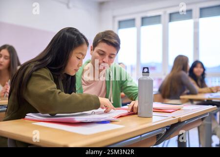 Institute students collaborating on project in classroom environment Stock Photo