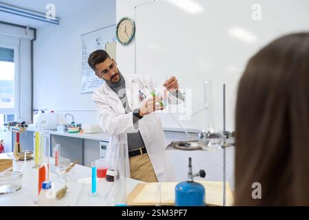 Chemistry teacher performing experiment for students in laboratory Stock Photo