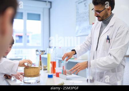 Students conducting chemistry experiment in university lab Stock Photo