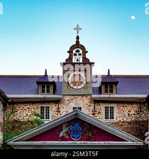 The historic Old Saint-Sulpice Seminary in Montreal, Quebec, featuring classic stone architecture, a clock tower, and intricate details under the sky Stock Photo