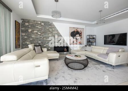 a close up image of luxury living room with two large leather sofas in mediterranean holiday home Stock Photo