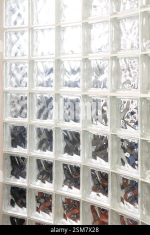 A wall of glass block curved with light shining through it.  Background abstract Stock Photo
