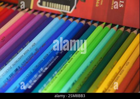 Coloured pencils. Brightly coloured pencils arranged in a row, ready for use. Art supplies for drawing and colouring. A rainbow of colours, inspiring Stock Photo