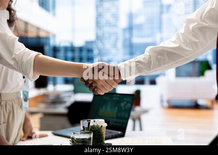 Recruiter shaking hands with person after finding best talent to fill open company position. HR department employee doing handshake with man after being happy with candidate skills and qualifications Stock Photo